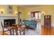 Living room featuring a fireplace with decorative sconces and views to other living spaces at 1208 College Pl, Raleigh, NC 27605