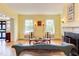 Open living room with hardwood floors, a fireplace, and views of the front entry and windows at 1208 College Pl, Raleigh, NC 27605