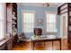 Office space with hardwood floors, large windows, built-in bookshelves, and classic finishes at 1208 College Pl, Raleigh, NC 27605