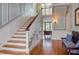 Elegant staircase featuring wood steps, white risers, and paneled walls offering a grand entrance at 1208 College Pl, Raleigh, NC 27605