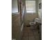 Bathroom featuring yellow tile, a combination tub-shower, and an updated toilet and sink at 1210 Cypress St, Rocky Mount, NC 27801