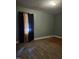 Bedroom featuring green painted walls, wood floors, and a window with curtains at 1210 Cypress St, Rocky Mount, NC 27801