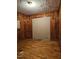 Bedroom with wood paneled walls and ceiling damage at 1210 Cypress St, Rocky Mount, NC 27801