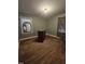 Bedroom featuring green painted walls, wood floors, and a mirror next to the window at 1210 Cypress St, Rocky Mount, NC 27801