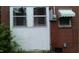 An exterior view showing the side of the home, with a wall and windows at 1210 Cypress St, Rocky Mount, NC 27801