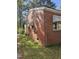 This brick home has windows with awnings and a lawn at 1210 Cypress St, Rocky Mount, NC 27801