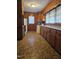 Classic kitchen with wooden cabinets, a window over the sink, and parquet flooring at 1210 Cypress St, Rocky Mount, NC 27801