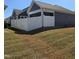 View of the backyard featuring a white fence, green grass, and adjacent house at 1217 Linkwood Way, Fuquay Varina, NC 27526