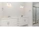 Bright bathroom with double sink vanity, white cabinets, quartz countertop and marble tile shower at 1217 Linkwood Way, Fuquay Varina, NC 27526