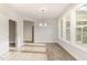 Dining area with hardwood floors, abundant natural light, and a modern chandelier at 1217 Linkwood Way, Fuquay Varina, NC 27526