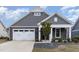 Charming single-story home with stone and gray siding and a two-car garage at 1217 Linkwood Way, Fuquay Varina, NC 27526