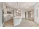 Modern kitchen boasts gray cabinets, an island with a sink, stainless appliances, and an open layout at 1217 Linkwood Way, Fuquay Varina, NC 27526