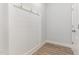 Mudroom with board and batten wall, hooks, and wood-look flooring at 1217 Linkwood Way, Fuquay Varina, NC 27526