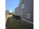 Side yard with landscaping, grass, and exterior of house at 1217 Linkwood Way, Fuquay Varina, NC 27526