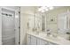 Bright bathroom features a double vanity with white cabinetry, large mirror, and shower-tub combo at 1505 Starmont Dr, Hillsborough, NC 27278