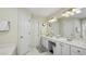 Well-lit bathroom with double vanity, white cabinets, and framed mirrors, plus a walk-in shower at 1505 Starmont Dr, Hillsborough, NC 27278