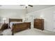 Bedroom with a wooden sleigh bed frame, dresser, neutral walls, and carpet flooring at 1505 Starmont Dr, Hillsborough, NC 27278
