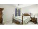 Cozy bedroom with a wooden bed frame, bedside table, and natural light from a window at 1505 Starmont Dr, Hillsborough, NC 27278