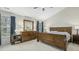 Bedroom with two windows and wooden furniture, including a bed frame and dresser with mirror at 1505 Starmont Dr, Hillsborough, NC 27278