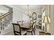 Traditional dining room with chandelier, wood table, and staircase view, perfect for Gathering gatherings at 1505 Starmont Dr, Hillsborough, NC 27278