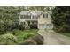 Charming two-story home featuring a well-manicured lawn, lush landscaping, and a two-car garage at 1505 Starmont Dr, Hillsborough, NC 27278