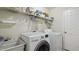 Functional laundry room equipped with a washer, dryer, sink, and shelving for storage at 1505 Starmont Dr, Hillsborough, NC 27278