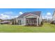 Spacious backyard with a well-maintained lawn, a screened-in porch, and a glimpse of a car and houses at 153 Tennyson Dr # 235, Garner, NC 27529