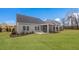 Spacious backyard featuring a well-maintained lawn, screened porch and new construction in the background at 153 Tennyson Dr # 235, Garner, NC 27529