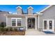 The front of a gray two-story house featuring dormers, a covered entryway, and meticulously maintained landscaping at 153 Tennyson Dr # 235, Garner, NC 27529