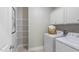 Efficient laundry room with ample cabinet space and modern washer and dryer units for convenient chores at 153 Tennyson Dr # 235, Garner, NC 27529
