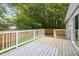 Lovely back deck with a white railing overlooks a green and treed backyard at 1615 Malta Ave, Raleigh, NC 27610