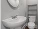 Bathroom with large sink, mirror, toilet and shelving at 1615 Malta Ave, Raleigh, NC 27610