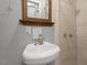 Bathroom sink and mirror, with tile walls at 1615 Malta Ave, Raleigh, NC 27610