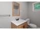 Modern bathroom with wood vanity and a well lit space at 1615 Malta Ave, Raleigh, NC 27610