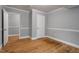 Bedroom with closet, hardwood floors, neutral paint and white trim at 1615 Malta Ave, Raleigh, NC 27610