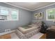 Bedroom staged with a plush bed, side table, and modern artwork at 1615 Malta Ave, Raleigh, NC 27610
