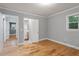 Bright bedroom with hardwood floors offering access to additional rooms at 1615 Malta Ave, Raleigh, NC 27610