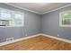 Bedroom with hardwood floors and natural light coming through the windows at 1615 Malta Ave, Raleigh, NC 27610