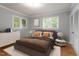 Neutral bedroom featuring hardwood floors, natural light, and modern furnishings and decor at 1615 Malta Ave, Raleigh, NC 27610