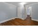 Bedroom with closet, dark wood floors, neutral paint and white trim at 1615 Malta Ave, Raleigh, NC 27610