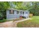 Charming home exterior with a well-maintained yard and inviting entrance stairs at 1615 Malta Ave, Raleigh, NC 27610