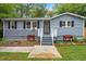 Charming single-Gathering home with a walkway, lawn, garden, and stairway to the front door at 1615 Malta Ave, Raleigh, NC 27610