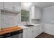 Bright kitchen featuring stainless steel appliances, granite countertops, and modern backsplash at 1615 Malta Ave, Raleigh, NC 27610