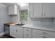 Bright kitchen featuring stainless steel appliances, granite countertops, and modern backsplash at 1615 Malta Ave, Raleigh, NC 27610