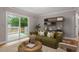 Bright living room with sliding door access to a deck and stylish shelving for a modern touch at 1615 Malta Ave, Raleigh, NC 27610