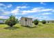 Backyard featuring a storage shed, green grass and scattered bushes at 162 E Abbey Ct, Smithfield, NC 27577