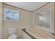 Relaxing bathroom with soaking tub, natural light and decorative mirror at 162 E Abbey Ct, Smithfield, NC 27577