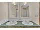Bathroom showcasing double sinks with green countertops and framed mirrors at 162 E Abbey Ct, Smithfield, NC 27577
