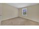 Neutral carpeted bedroom features a window with a view at 162 E Abbey Ct, Smithfield, NC 27577