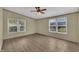 Bedroom featuring wood-look flooring, ceiling fan, and two windows at 162 E Abbey Ct, Smithfield, NC 27577